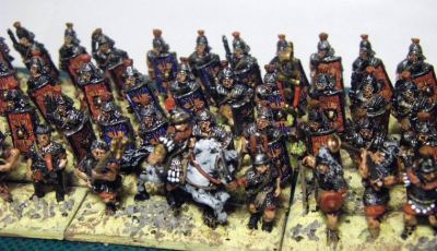 Early Imperial Roman Legionaries
Old Glory legionaries with Donnington, Corvus Belli and Essex officers and LBMS shield transfers. A rare "on the painting table" shot as they have not yet been matt varnished or had static grass added to the bases. 
Keywords: EIR