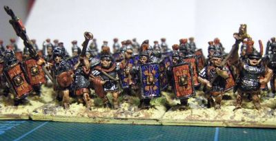 Early Imperial Roman Legionaries
Old Glory legionaries with Donnington, Corvus Belli and Essex officers and LBMS shield transfers. A rare "on the painting table" shot as they have not yet been matt varnished or had static grass added to the bases. 
Keywords: EIR